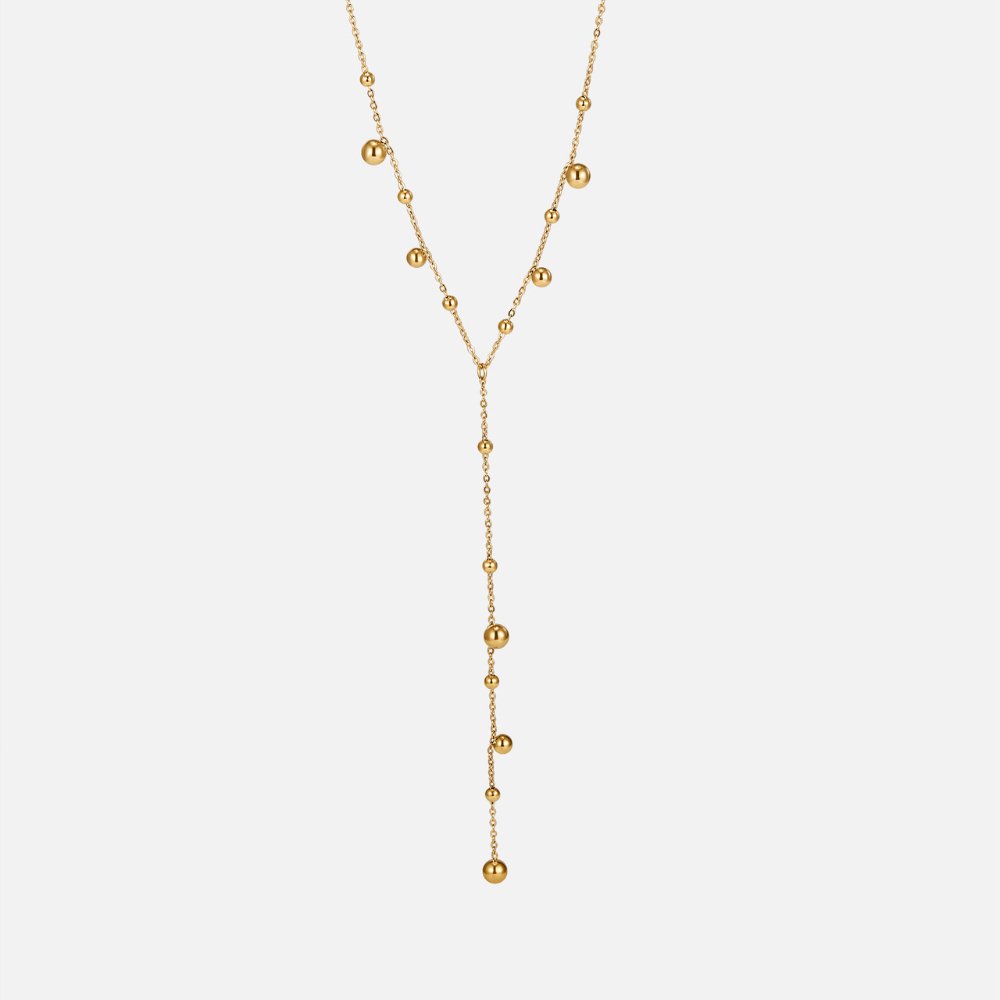Collar con perlas doradas y borlas