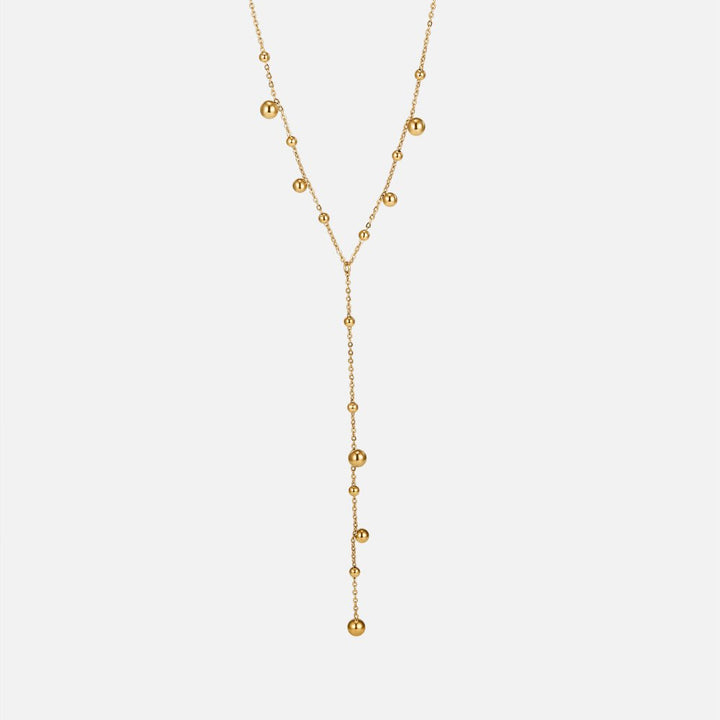 Collar con perlas doradas y borlas