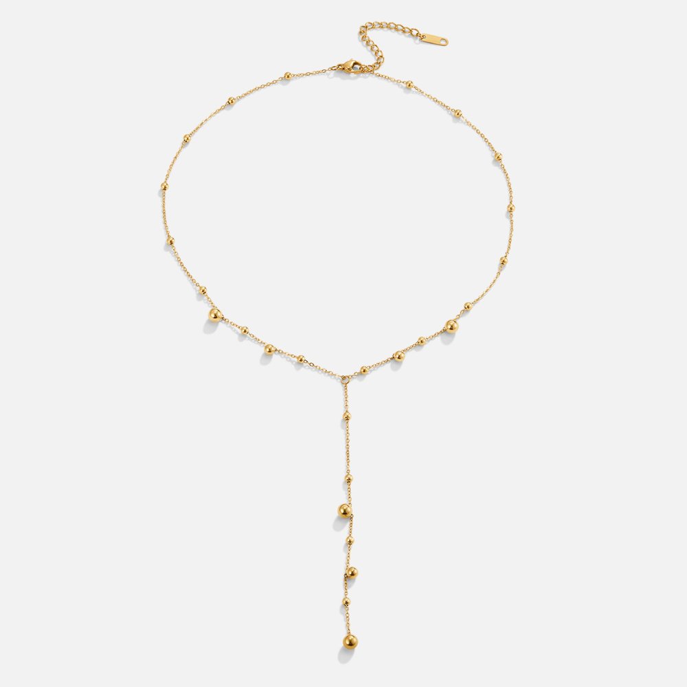 Collar con perlas doradas y borlas